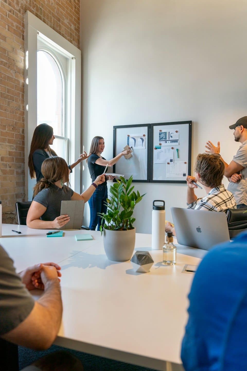 Services Diverse team collaborating around a conference table.
