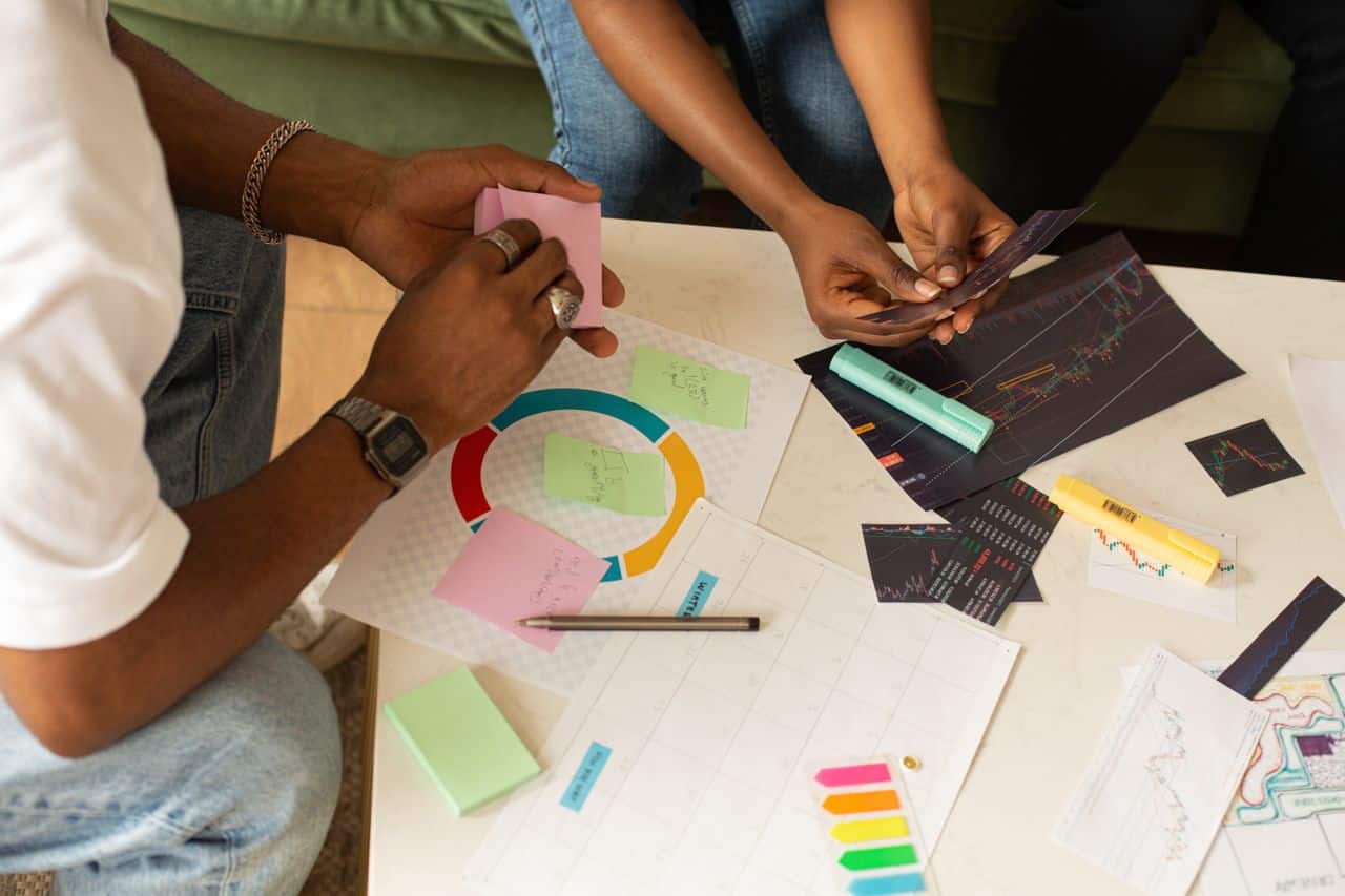 Mastering the First Impression: Your intriguing post title goes here Team collaborates using charts and sticky notes for planning and analysis.